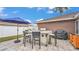 This outdoor kitchen boasts stainless steel appliances, a built-in grill, and a spacious countertop with seating for four at 5246 Montserrat Dr, Lakeland, FL 33812