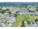 Expansive aerial view of a residential community next to a golf course, showcasing the neighborhood layout and green spaces at 525 Eagle Run, Lakeland, FL 33809