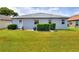 This property features a well maintained lawn with manicured shrubbery at 525 Eagle Run, Lakeland, FL 33809