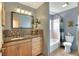 Bathroom featuring wood vanity, decorative mirror, and bathtub with a shower at 525 Eagle Run, Lakeland, FL 33809