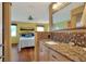 Bathroom featuring granite counters, wood cabinets, and bedroom view with a large mirror at 525 Eagle Run, Lakeland, FL 33809