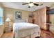 Bedroom features wood floors, ceiling fan, window with blinds, and wardrobe closet at 525 Eagle Run, Lakeland, FL 33809