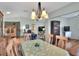 Charming dining area featuring a hardwood floor, natural light, a chandelier, and an open view to the living room at 525 Eagle Run, Lakeland, FL 33809