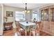 Inviting dining room featuring hardwood floors, natural lighting, a chandelier, and a view into an adjacent room at 525 Eagle Run, Lakeland, FL 33809