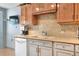 Bright kitchen featuring cabinets, neutral countertops, a stylish backsplash, and modern fixtures at 525 Eagle Run, Lakeland, FL 33809