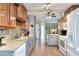 Spacious kitchen with wooden cabinets, tile backsplash, updated appliances, and an inviting breakfast bar at 525 Eagle Run, Lakeland, FL 33809