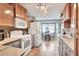 Well-lit kitchen featuring tile floors, wooden cabinets, modern appliances, and a cozy breakfast nook at 525 Eagle Run, Lakeland, FL 33809