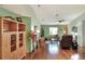 Open-concept living room featuring hardwood floors, a ceiling fan, and comfortable seating arrangement with side tables at 525 Eagle Run, Lakeland, FL 33809