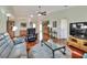 Bright and open living room with hardwood floors, comfortable seating, and a ceiling fan at 525 Eagle Run, Lakeland, FL 33809