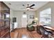 Versatile office space featuring hardwood floors, a ceiling fan, natural light, and built-in desk with chair at 525 Eagle Run, Lakeland, FL 33809