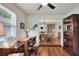 Well-lit office featuring hardwood floors, a built-in desk, and a view into the dining room at 525 Eagle Run, Lakeland, FL 33809