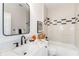 Well-lit bathroom with a large mirror, modern fixtures, and stylish black and white accents at 527 W Park St, Lakeland, FL 33803