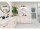 Elegant bathroom with dual sinks, stylish mirrors, and modern black and white tile flooring at 527 W Park St, Lakeland, FL 33803