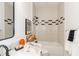 Well-lit bathroom with a large mirror, modern fixtures, and stylish black and white accents at 527 W Park St, Lakeland, FL 33803