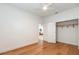 Bright bedroom with hardwood floors, closet, ceiling fan and view to the living room at 527 W Park St, Lakeland, FL 33803