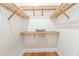 Walk-in closet with custom wooden shelving provides ample storage space and a clean, organized look at 527 W Park St, Lakeland, FL 33803