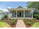 Inviting home with landscaped front yard and spacious front porch with classic columns and seating at 527 W Park St, Lakeland, FL 33803