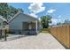 Charming home with a porch and a brick driveway leading to the front door on a sunny day at 527 W Park St, Lakeland, FL 33803