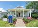Charming home featuring a welcoming front porch, manicured landscaping, and a brick pathway at 527 W Park St, Lakeland, FL 33803