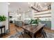 Open-concept kitchen with hardwood floors, island, modern cabinets, and views of the dining room at 527 W Park St, Lakeland, FL 33803