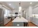 Well-designed kitchen with island, pendant lighting, gray cabinets, and stainless steel appliances at 527 W Park St, Lakeland, FL 33803