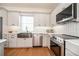 Bright kitchen featuring stainless steel appliances, modern cabinetry, and a stylish backsplash at 527 W Park St, Lakeland, FL 33803