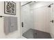 Modern shower featuring subway tile, a frameless glass door, and sleek black hardware at 527 W Park St, Lakeland, FL 33803