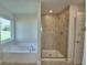 Bathroom with soaking tub, and separate glass-enclosed shower at 580 Jett Ln, Davenport, FL 33837