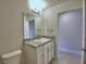 Bright bathroom featuring a granite vanity top and white cabinets at 580 Jett Ln, Davenport, FL 33837