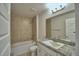 Bright bathroom featuring a tub with tile surround and a granite vanity top at 580 Jett Ln, Davenport, FL 33837