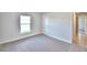 Carpeted bedroom with a window and neutral walls at 580 Jett Ln, Davenport, FL 33837