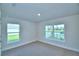 Inviting bedroom with large windows offering picturesque outdoor views and neutral carpet at 580 Jett Ln, Davenport, FL 33837