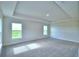 Spacious carpeted bedroom featuring multiple windows and a tray ceiling at 580 Jett Ln, Davenport, FL 33837