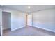 Bright, carpeted bedroom showing a walk-in closet and neutral-colored walls at 580 Jett Ln, Davenport, FL 33837