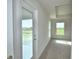 Carpeted bedroom featuring multiple windows and a tray ceiling at 580 Jett Ln, Davenport, FL 33837