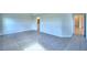 Large carpeted bedroom featuring two entryways and three windows at 580 Jett Ln, Davenport, FL 33837
