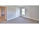 Comfortable bedroom bathed in natural light features a window and neutral carpet at 580 Jett Ln, Davenport, FL 33837
