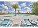Expansive community pool area with lounge chairs and a splash pad for Gathering fun and relaxation at 580 Jett Ln, Davenport, FL 33837