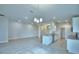 Open-concept kitchen with granite countertops, stainless steel appliances, and tile flooring, adjacent to a large living space at 580 Jett Ln, Davenport, FL 33837