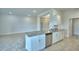 Modern kitchen island with a stainless steel sink, dishwasher, and ample cabinet space, perfect for meal preparation at 580 Jett Ln, Davenport, FL 33837
