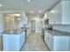 Open kitchen with white cabinets, stainless steel appliances, granite countertops, and a convenient breakfast bar at 580 Jett Ln, Davenport, FL 33837