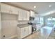 This kitchen is fully equipped with stainless steel appliances and pristine white cabinets at 580 Jett Ln, Davenport, FL 33837