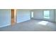 Bright main bedroom with plush carpeting and ensuite bathroom access offers comfortable, modern living at 580 Jett Ln, Davenport, FL 33837