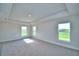 Sun-filled main bedroom with tray ceiling and large windows offering scenic outdoor views at 580 Jett Ln, Davenport, FL 33837