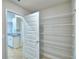 Spacious walk-in pantry with ample shelving, conveniently located adjacent to the kitchen at 580 Jett Ln, Davenport, FL 33837