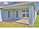 Covered outdoor patio with double doors and large window at 580 Jett Ln, Davenport, FL 33837