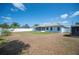 Spacious backyard showcasing a fenced perimeter, mature landscaping, and a screened-in porch at 603 Reflections Loop, Winter Haven, FL 33884