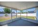 Screened-in patio overlooking a spacious, fenced backyard with mature trees and landscaping at 603 Reflections Loop, Winter Haven, FL 33884