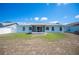 Exterior shot of house showing back yard with porch at 603 Reflections Loop, Winter Haven, FL 33884