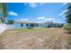 Wide backyard view features white fencing, mature trees, a covered patio, and additional outdoor features at 603 Reflections Loop, Winter Haven, FL 33884